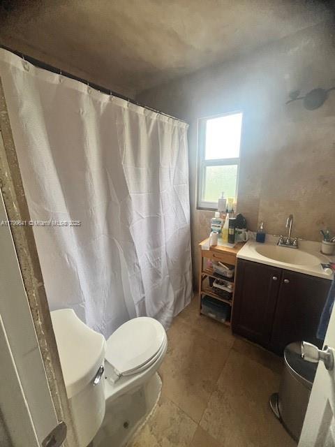 717 NW 1st St, Hallandale Beach, FL 33009 - full bath with toilet, vanity, and a shower with shower curtain