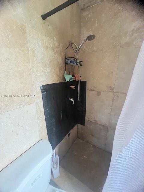 717 NW 1st St, Hallandale Beach, FL 33009 - bathroom view of a tile shower and toilet