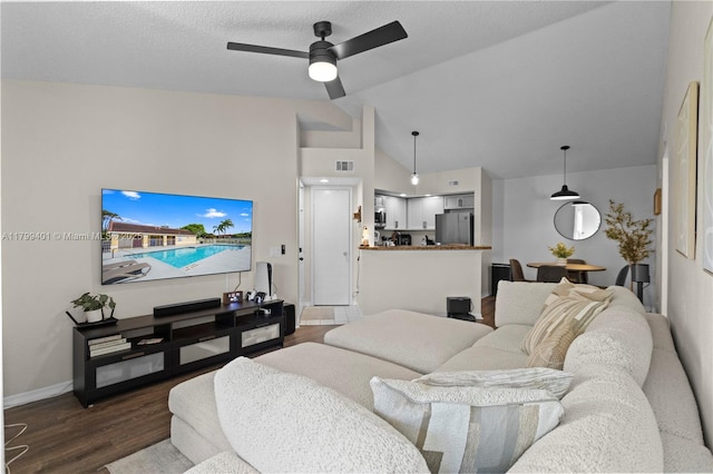 living area with dark wood-style floors, lofted ceiling, ceiling fan, and baseboards