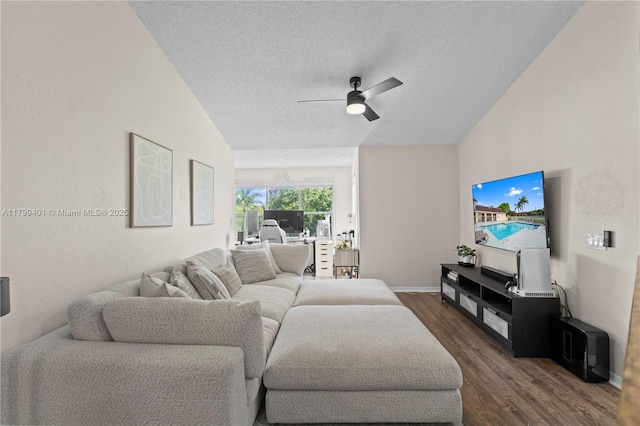 living area featuring dark wood-style flooring, ceiling fan, a textured ceiling, and baseboards