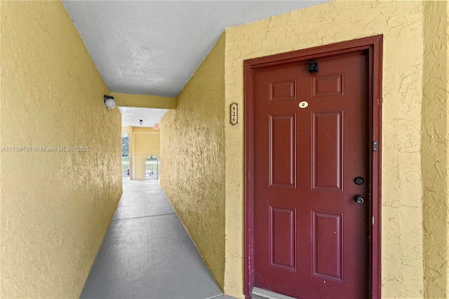 entrance to property featuring stucco siding