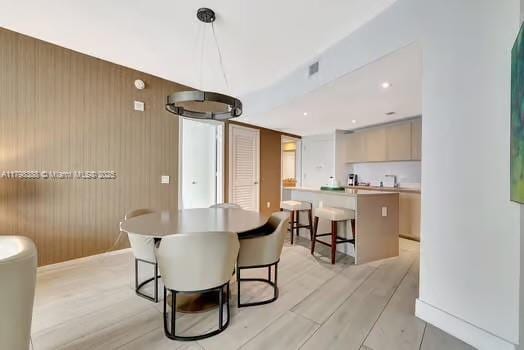 4111 S Ocean Dr Unit 3205, Hollywood, FL 33019 - dining space featuring light wood-style floors and wooden walls