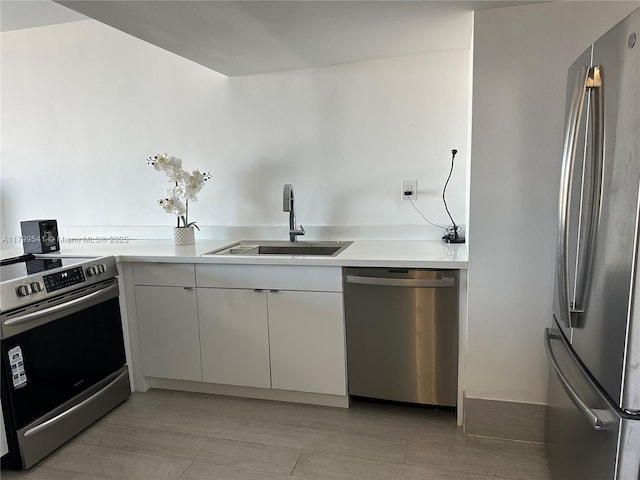 555 NE 15th St Unit 508, Miami, FL 33132 - kitchen featuring stainless steel appliances, a sink, white cabinetry, and light countertops