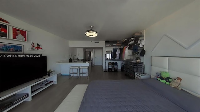 555 NE 15th St Unit 508, Miami, FL 33132 - bedroom featuring a sink, wood finished floors, and freestanding refrigerator