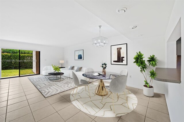 dining room featuring a chandelier and light tile patterned floors