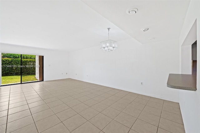 unfurnished living room featuring a chandelier, vaulted ceiling, and light tile patterned flooring