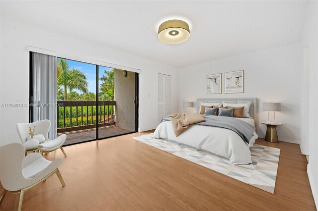 bedroom featuring access to exterior and wood finished floors