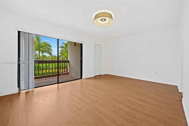 empty room with wood finished floors and baseboards