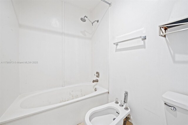 full bath with toilet, washtub / shower combination, and a bidet