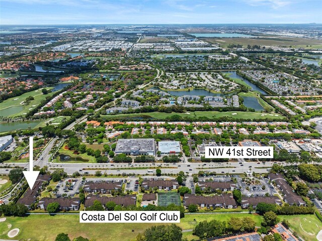 view of property location featuring a nearby body of water and a golf club