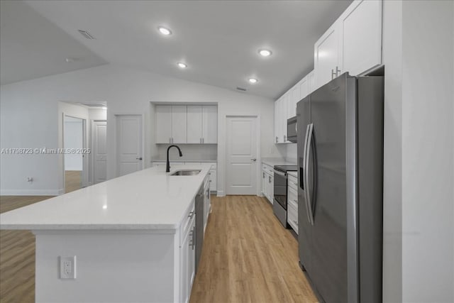 2048 NW 3rd Ter, Cape Coral, FL 33993 - kitchen featuring appliances with stainless steel finishes, a sink, lofted ceiling, light wood-style flooring, and white cabinetry