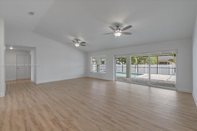 2048 NW 3rd Ter, Cape Coral, FL 33993 - unfurnished living room with lofted ceiling, a ceiling fan, light wood-type flooring, and baseboards