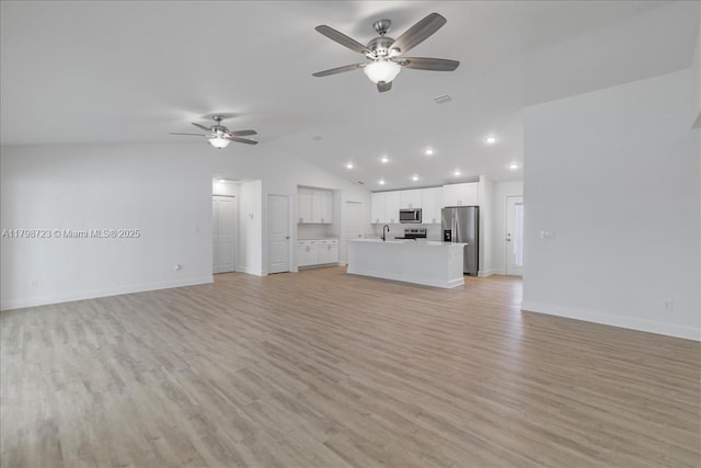 2048 NW 3rd Ter, Cape Coral, FL 33993 - unfurnished living room with ceiling fan, lofted ceiling, baseboards, light wood finished floors, and recessed lighting