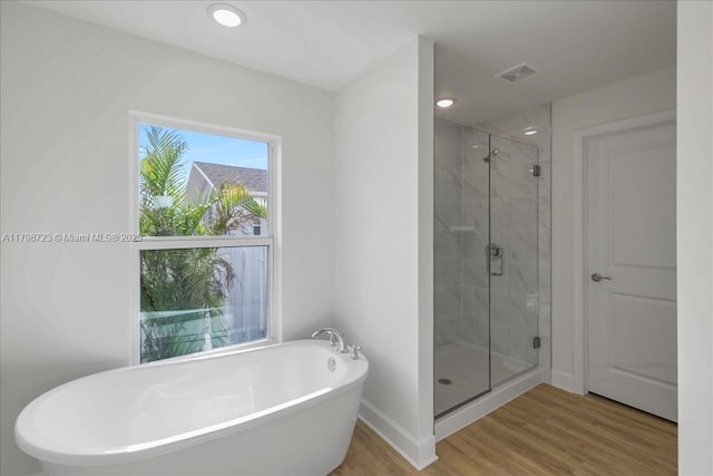 2048 NW 3rd Ter, Cape Coral, FL 33993 - full bath with a stall shower, a freestanding bath, wood finished floors, recessed lighting, and baseboards