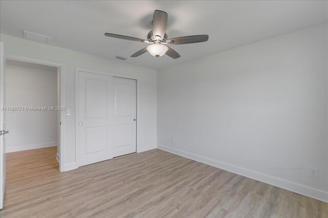 2048 NW 3rd Ter, Cape Coral, FL 33993 - unfurnished bedroom featuring light wood-type flooring, a closet, baseboards, and a ceiling fan