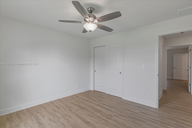 2048 NW 3rd Ter, Cape Coral, FL 33993 - unfurnished bedroom with baseboards, light wood-style flooring, and a closet