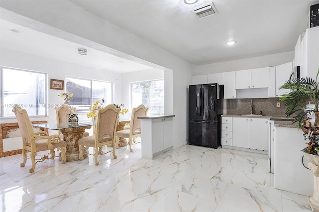 3241 SW 66th Ave, Miramar, FL 33023 - kitchen with freestanding refrigerator, a sink, backsplash, white cabinetry, and baseboards
