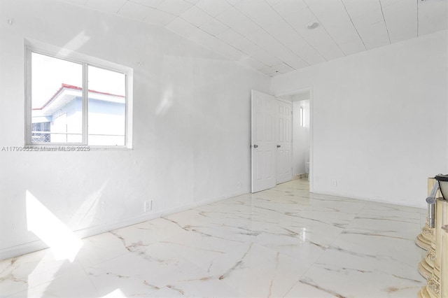 3241 SW 66th Ave, Miramar, FL 33023 - empty room featuring baseboards, marble look tiles, and vaulted ceiling