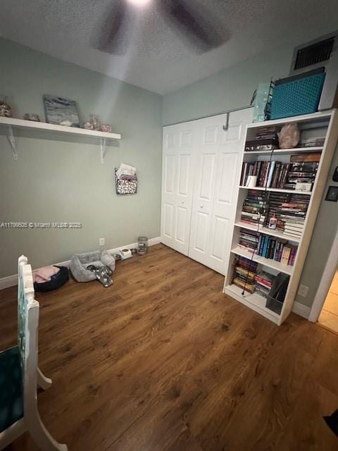 10047 Winding Lake Rd Unit 203, Sunrise, FL 33351 - bedroom featuring a textured ceiling, wood finished floors, baseboards, a closet, and ceiling fan