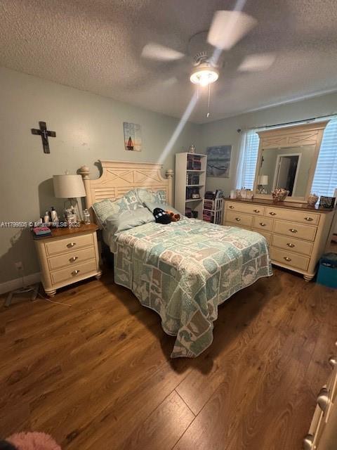 10047 Winding Lake Rd Unit 203, Sunrise, FL 33351 - bedroom with a textured ceiling, dark wood-style flooring, and ceiling fan