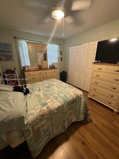10047 Winding Lake Rd Unit 203, Sunrise, FL 33351 - bedroom with dark wood-style flooring, a closet, a ceiling fan, and a textured ceiling