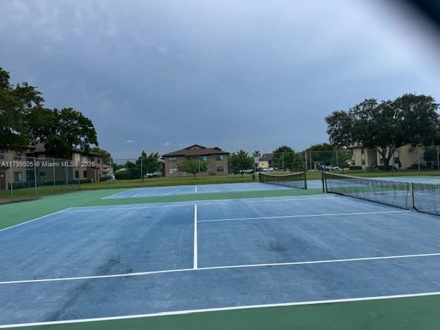 10047 Winding Lake Rd Unit 203, Sunrise, FL 33351 - view of tennis court with fence
