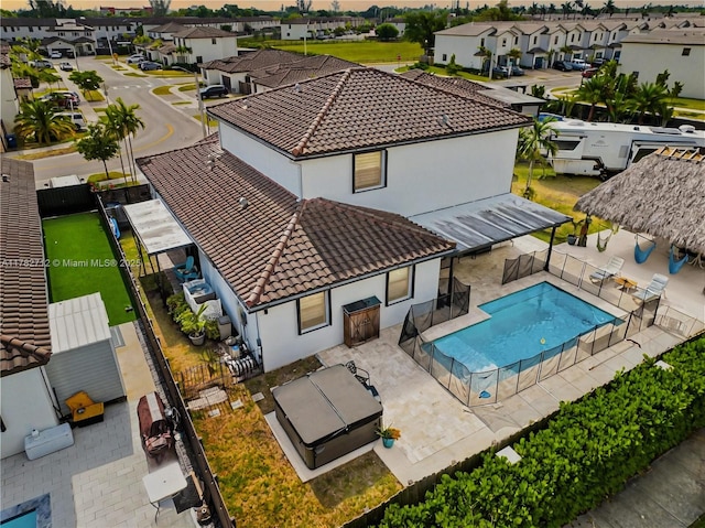22986 SW 128th Pl, Miami, FL 33170 - back of house featuring a tiled roof, stucco siding, a residential view, and a fenced backyard