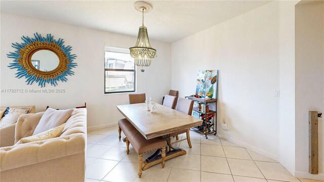 22986 SW 128th Pl, Miami, FL 33170 - dining space featuring a chandelier, light tile patterned floors, and baseboards