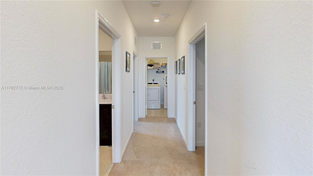 22986 SW 128th Pl, Miami, FL 33170 - corridor featuring washer / dryer, light carpet, baseboards, and recessed lighting