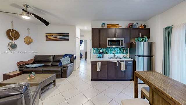 22986 SW 128th Pl, Miami, FL 33170 - kitchen with stainless steel appliances, open floor plan, a sink, ceiling fan, and light tile patterned floors