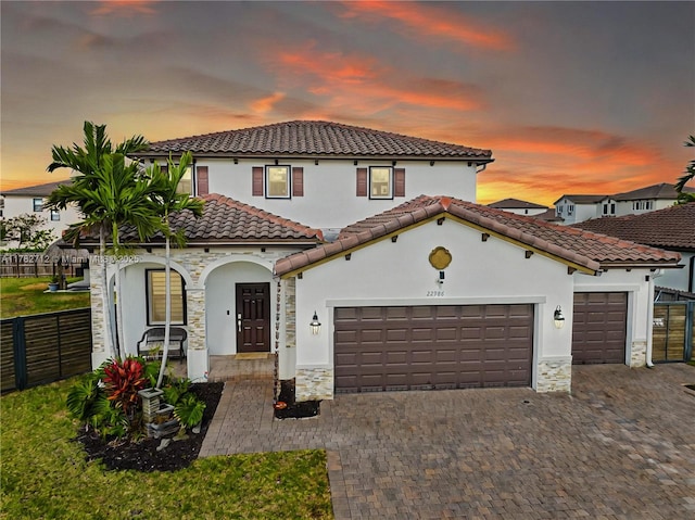 22986 SW 128th Pl, Miami, FL 33170 - mediterranean / spanish-style house with stone siding, a garage, fence, and stucco siding