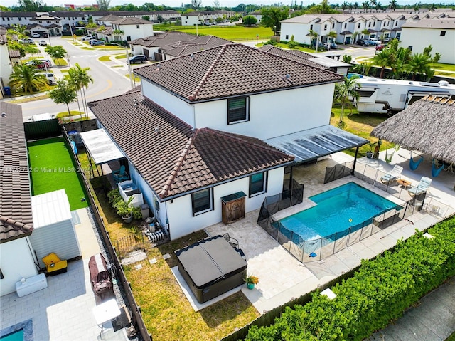 22986 SW 128th Pl, Miami, FL 33170 - back of property featuring a tile roof, a residential view, stucco siding, and a fenced backyard