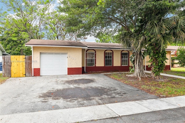 8101 NW 44th Ct, Lauderhill, FL 33351 - single story home with a garage, stucco siding, asphalt driveway, and brick siding