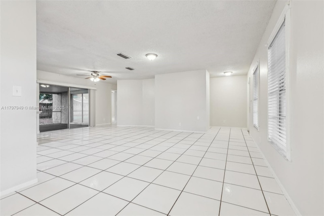 8101 NW 44th Ct, Lauderhill, FL 33351 - empty room featuring a textured ceiling, light tile patterned flooring, and a ceiling fan