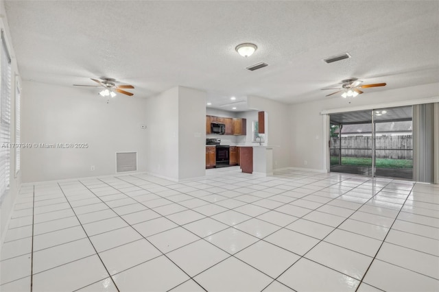 8101 NW 44th Ct, Lauderhill, FL 33351 - unfurnished living room with ceiling fan, a textured ceiling, and light tile patterned flooring