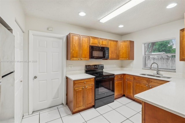 8101 NW 44th Ct, Lauderhill, FL 33351 - kitchen featuring black appliances, light countertops, a textured ceiling, brown cabinets, and light tile patterned flooring
