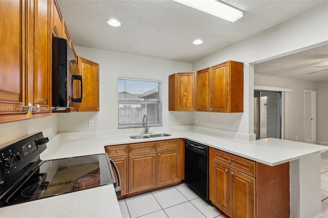 8101 NW 44th Ct, Lauderhill, FL 33351 - kitchen with black appliances, a textured ceiling, a peninsula, brown cabinets, and light countertops