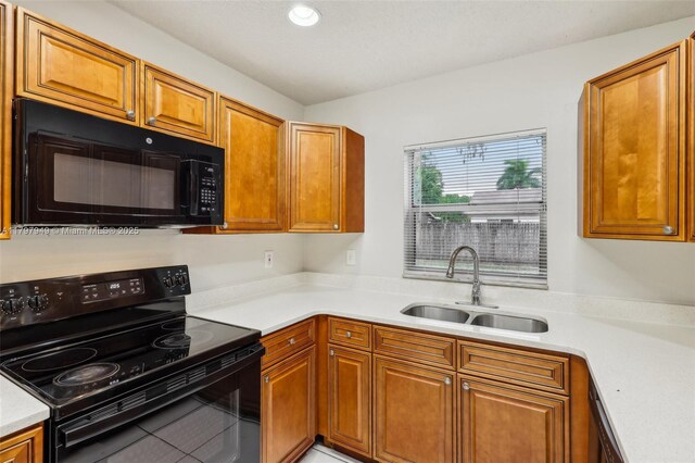 8101 NW 44th Ct, Lauderhill, FL 33351 - kitchen with black appliances, light countertops, brown cabinetry, and recessed lighting