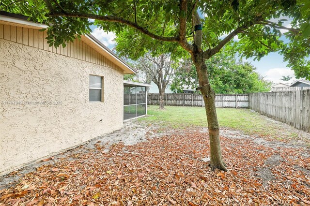 8101 NW 44th Ct, Lauderhill, FL 33351 - fenced backyard featuring a sunroom