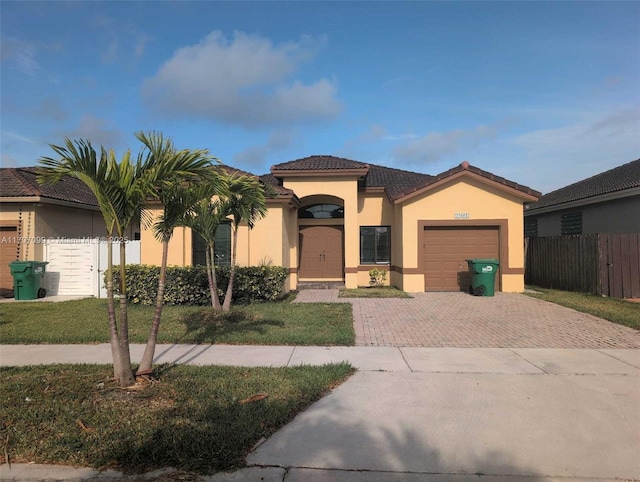 22664 SW 109th Path, Miami, FL 33170 - view of front facade with decorative driveway, an attached garage, stucco siding, and a tile roof