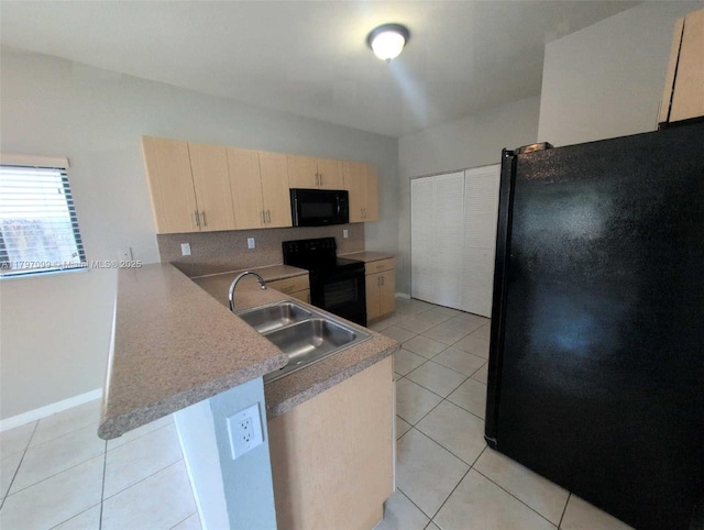 22664 SW 109th Path, Miami, FL 33170 - kitchen with black appliances, a sink, a peninsula, light brown cabinets, and light tile patterned flooring