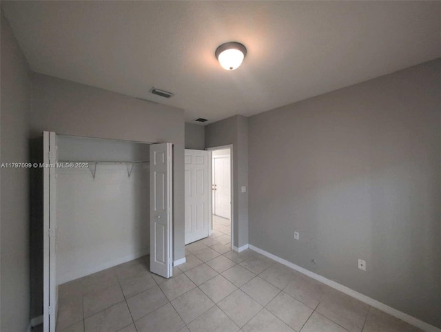 22664 SW 109th Path, Miami, FL 33170 - unfurnished bedroom with light tile patterned floors, a closet, and baseboards