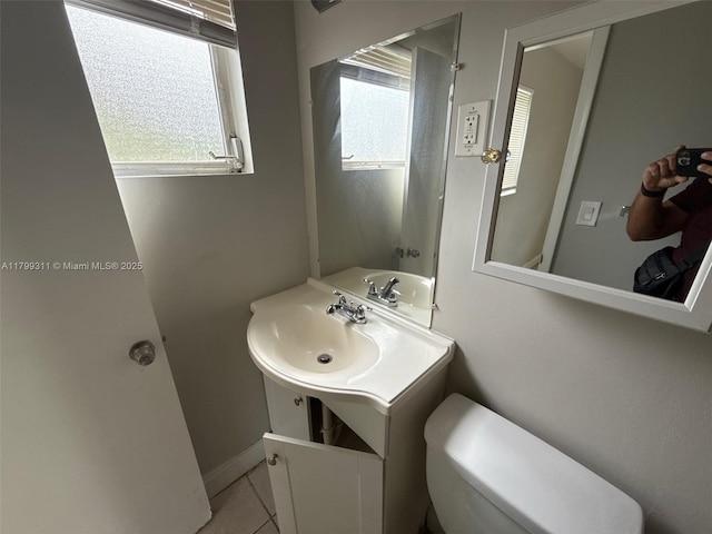 4920 NW 11th St, Lauderhill, FL 33313 - bathroom featuring tile patterned flooring, toilet, vanity, and baseboards