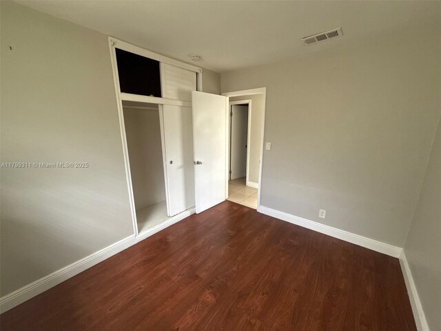 4920 NW 11th St, Lauderhill, FL 33313 - unfurnished bedroom featuring wood finished floors, baseboards, and a closet