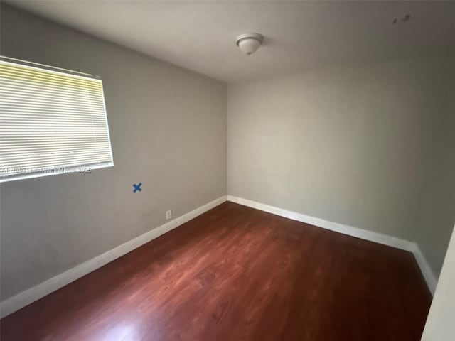 4920 NW 11th St, Lauderhill, FL 33313 - spare room with dark wood-style floors and baseboards