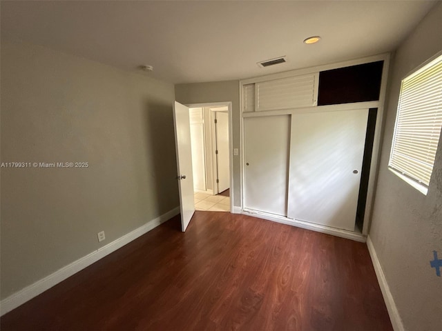 4920 NW 11th St, Lauderhill, FL 33313 - unfurnished bedroom with wood finished floors, baseboards, and a closet