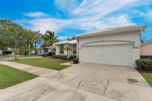 2625 SE 5th Ct, Homestead, FL 33033 - mediterranean / spanish home with concrete driveway, a front yard, stucco siding, and a tile roof
