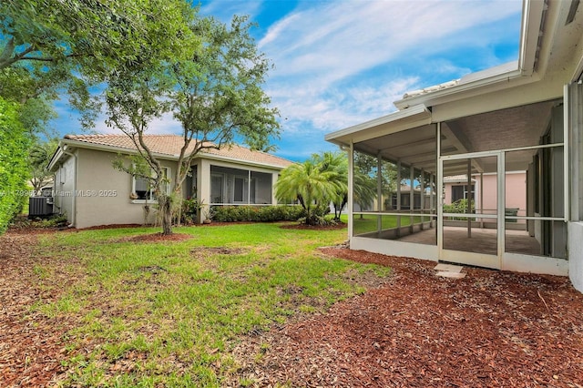 2625 SE 5th Ct, Homestead, FL 33033 - view of green lawn featuring a sunroom and central air condition unit