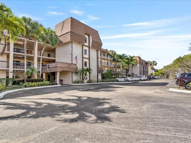 view of property with uncovered parking