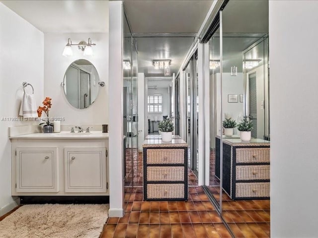 bathroom with vanity, wood finished floors, and baseboards